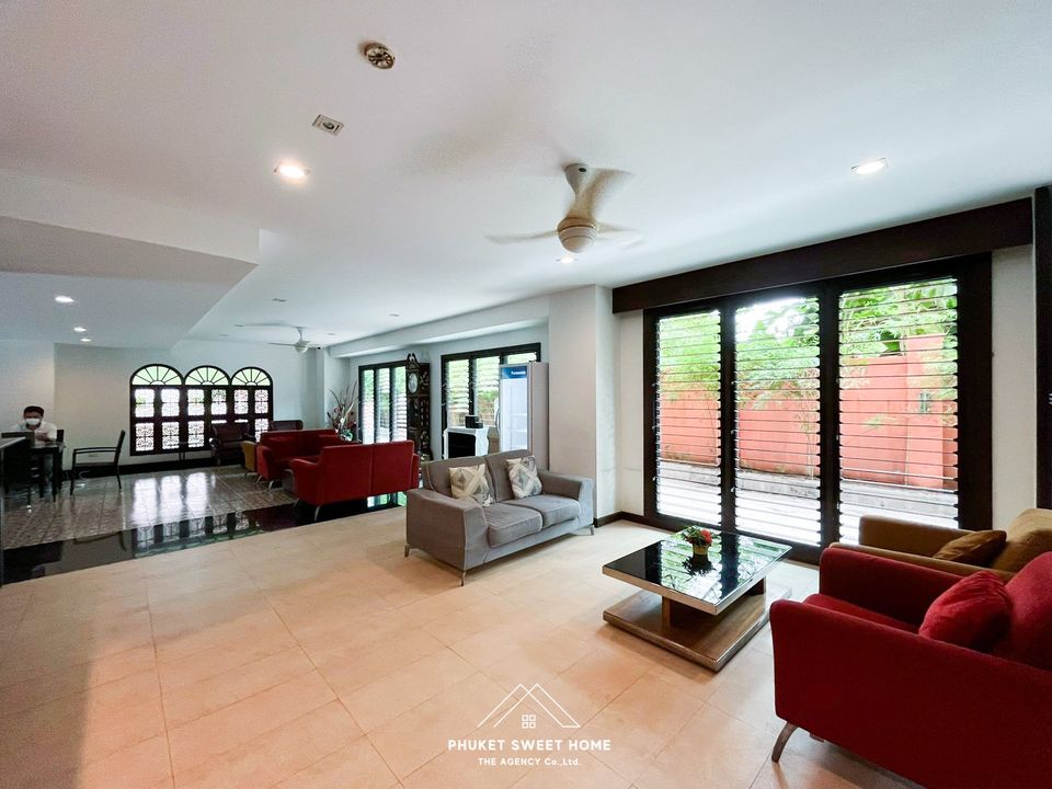 a living room filled with furniture and sliding glass doors