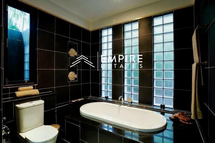 a bathroom with an oval tub and toilet