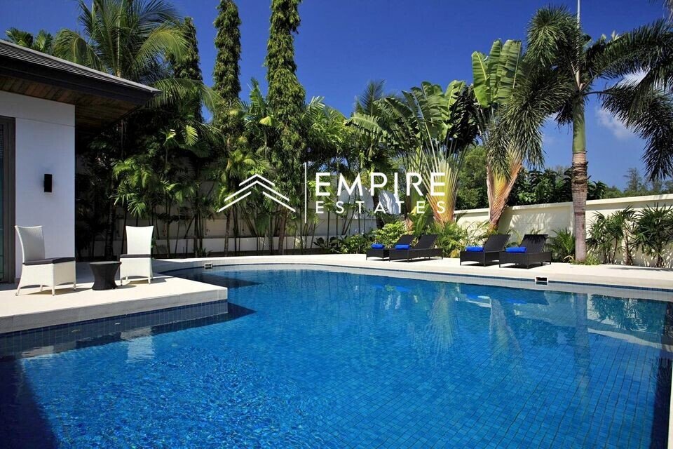 the pool in a modern mansion with trees in the background