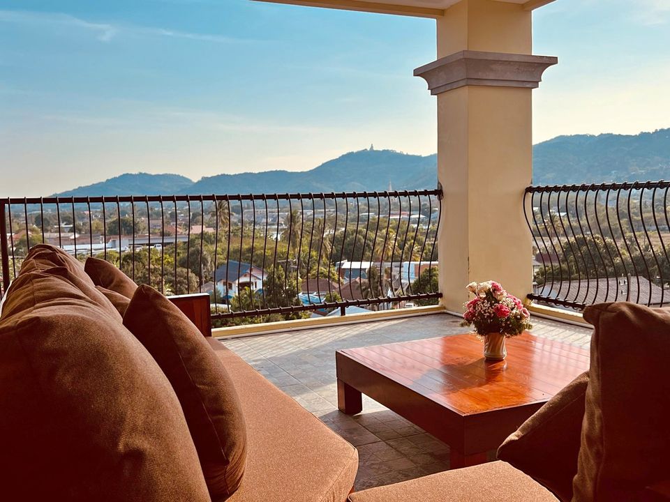 a balcony with a table and some couches on it